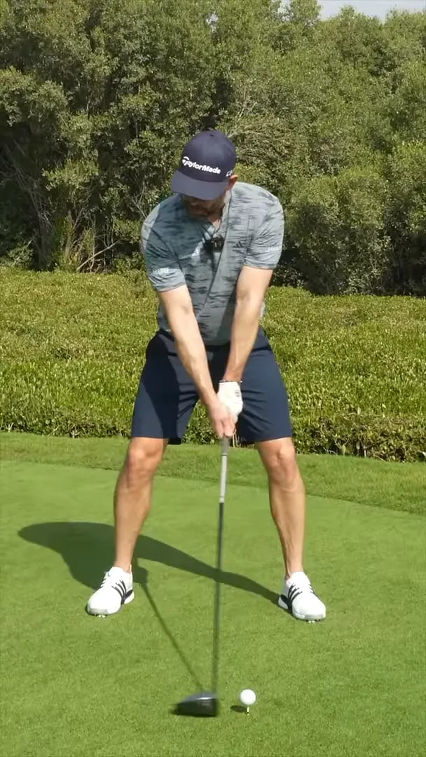 Golfer demonstrating takeaway with a circular highlight around the trail foot