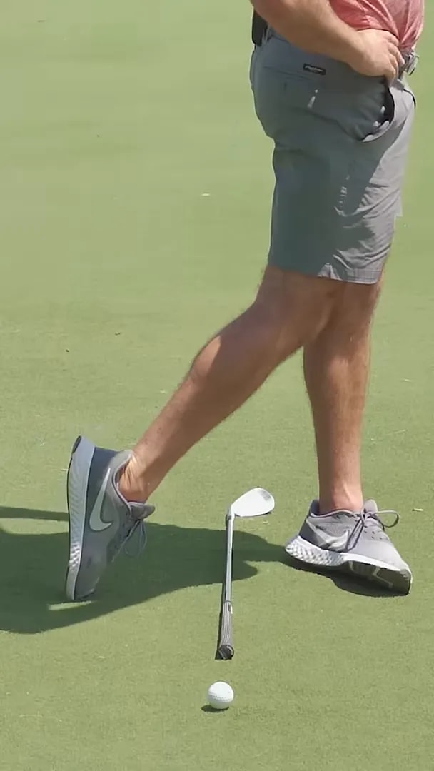 close view of golfer lower body with trail heel lifted and trail shoelaces turning toward target