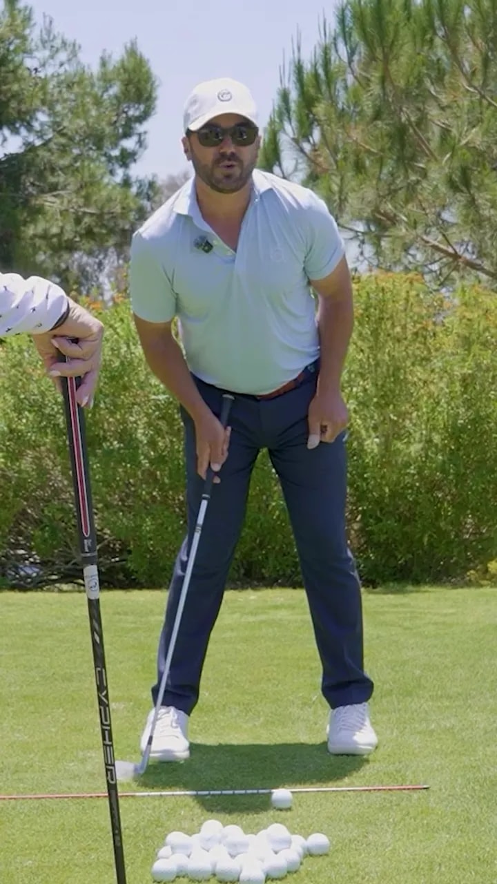 golfer in address posture pointing to trail side pressure and stance setup