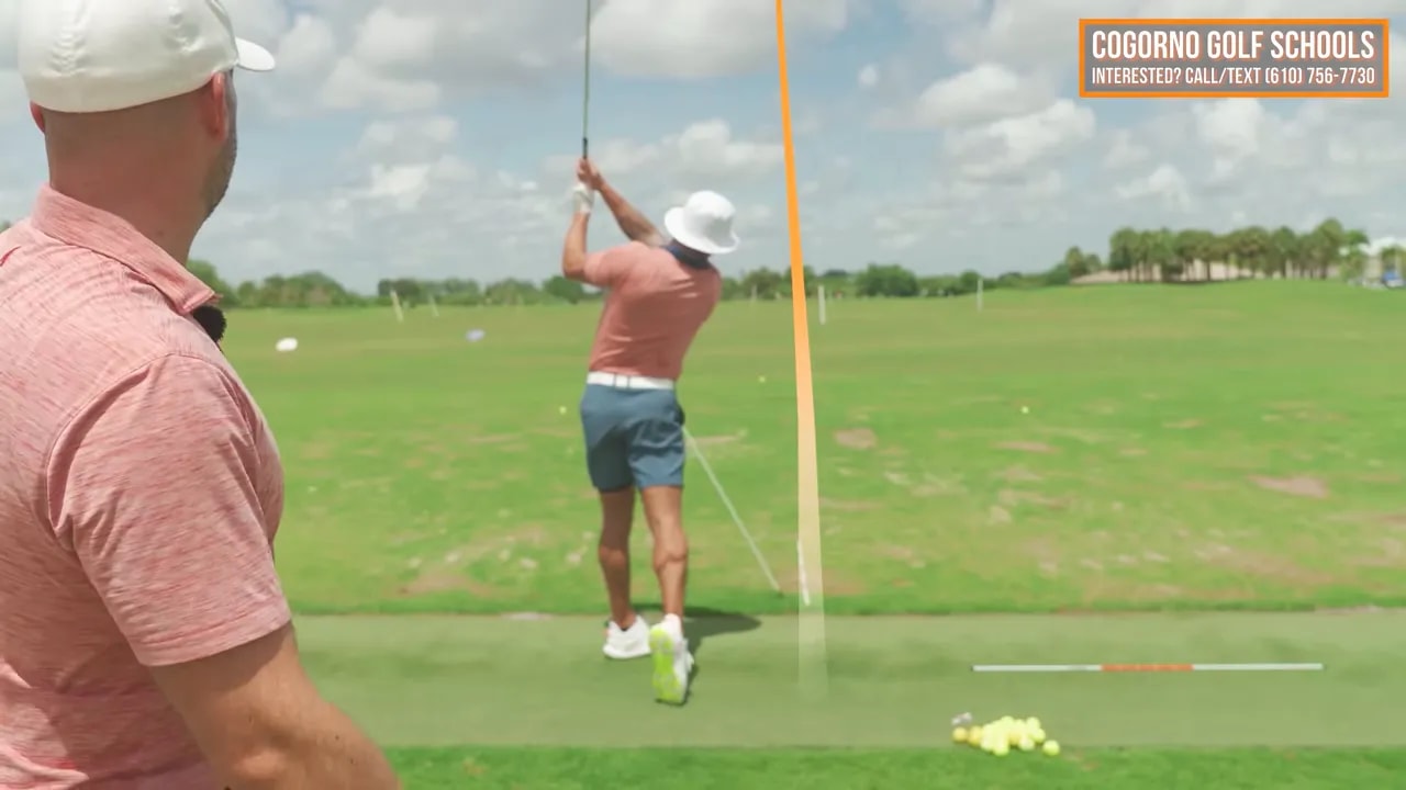 Golfer finishing a swing beside the alignment stick after a drawing ball flight