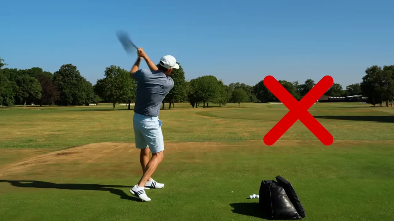 Golfer finishing a swing with a large red X beside him