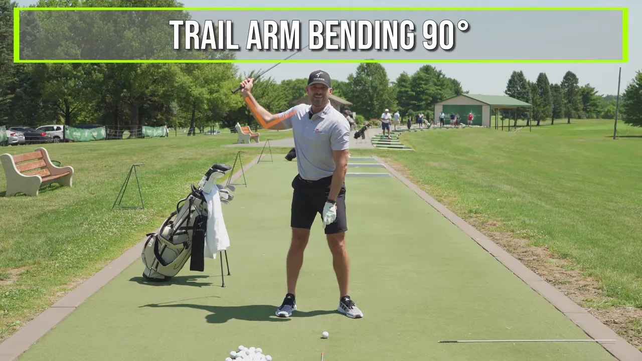 Golfer demonstrating a full swing trail arm with text reading trail arm bending 90 degrees