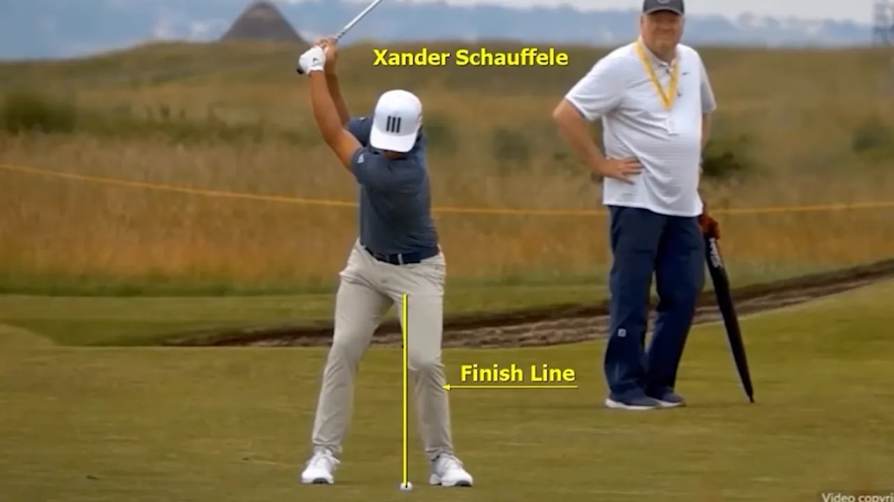 Xander Schauffele golf swing with a yellow finish line by the legs