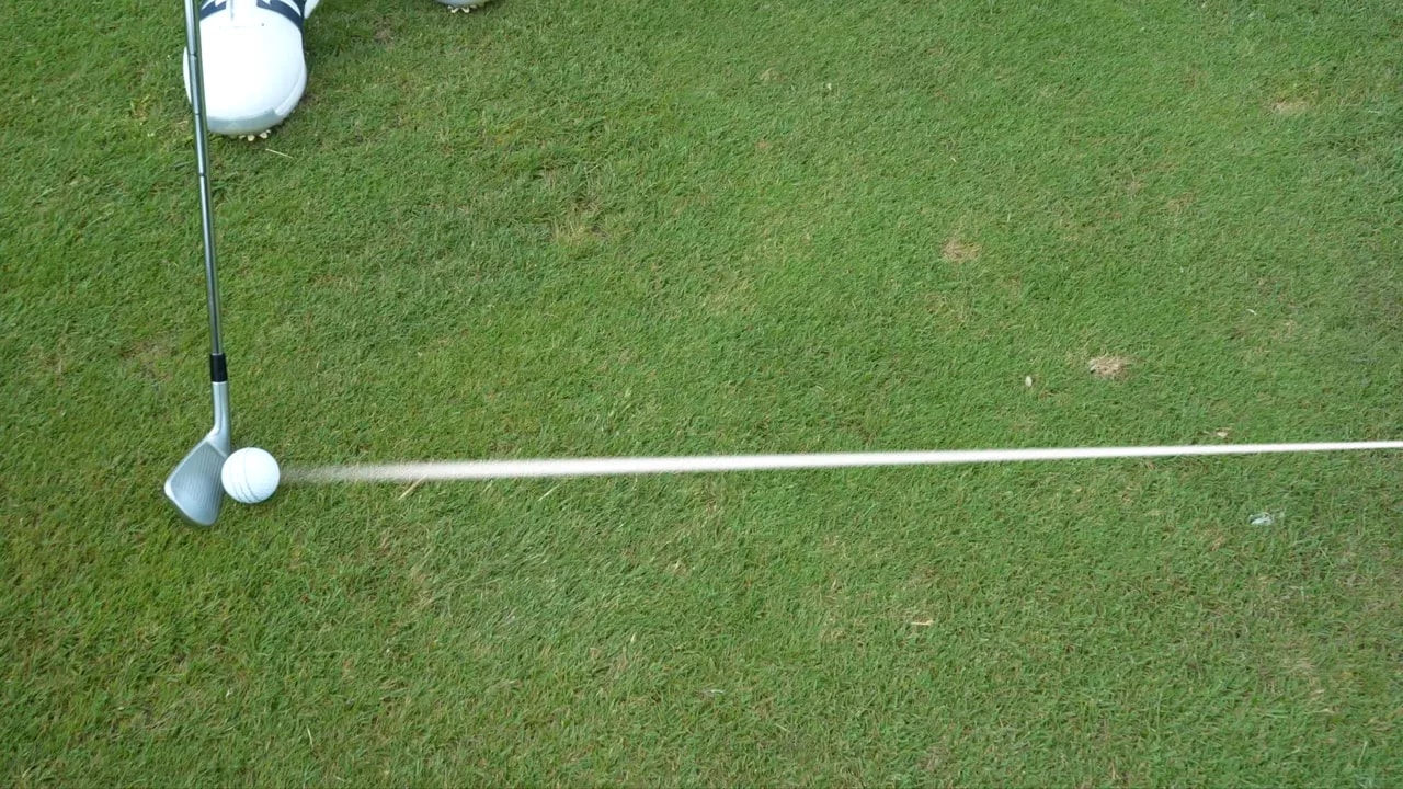 Top down view of golf ball and clubface with a white alignment line extending forward