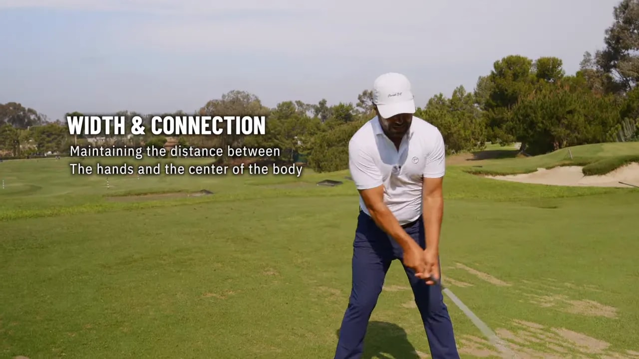 Golfer demonstrating width and connection during the swing