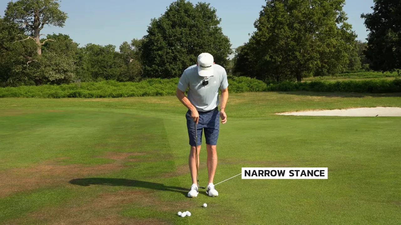 Close view of narrow golf stance with balls on the turf