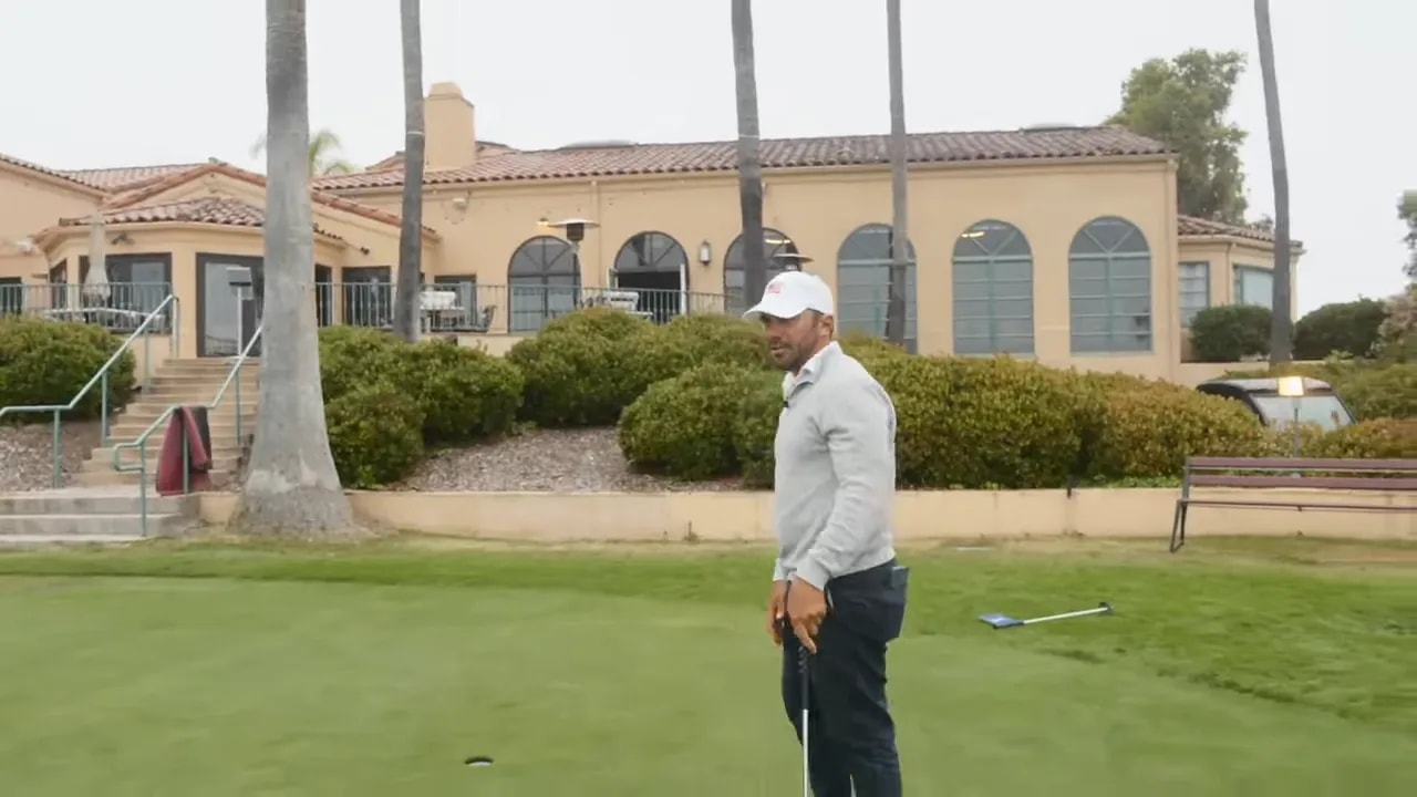 putting training aid placed perpendicular to the target line with ball and putter head