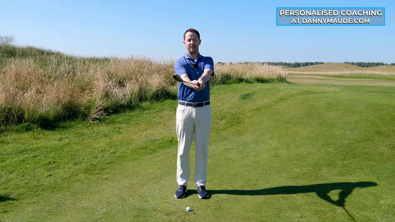 Front view of hands and club showing the thumbs down motion with the shaft leaning forward