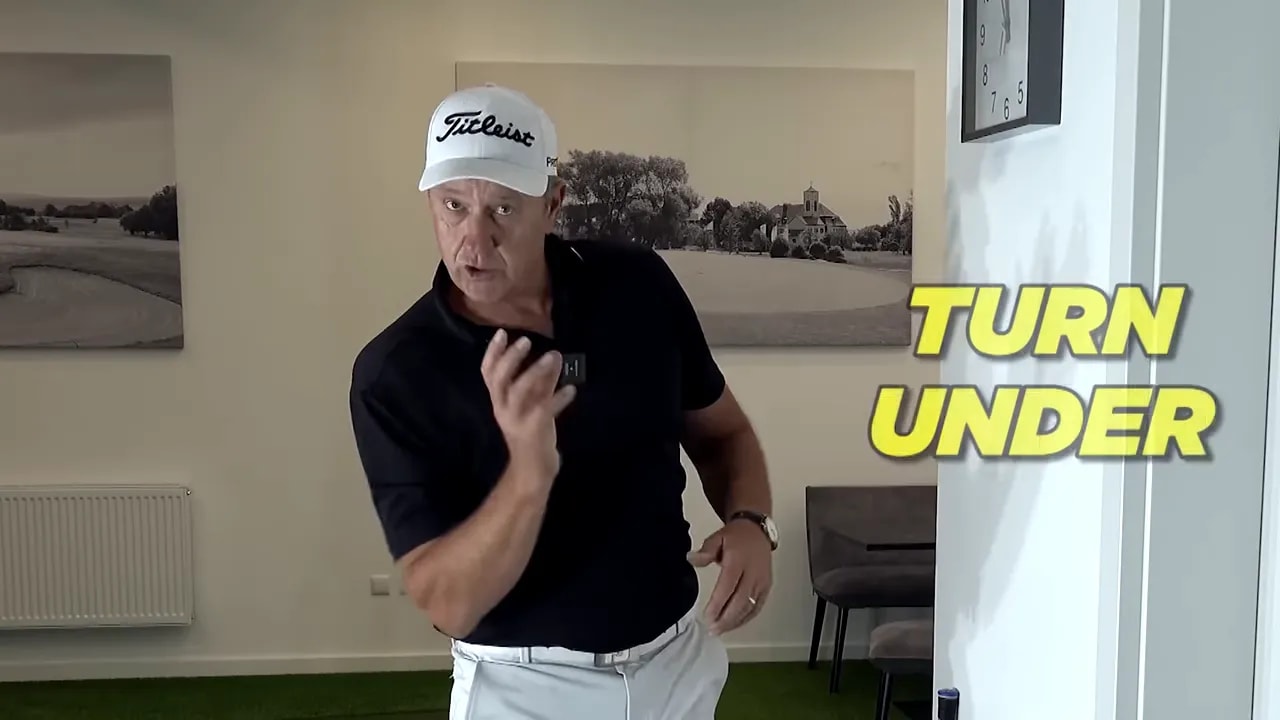 coach indoors beside wall with large yellow text reading TURN UNDER