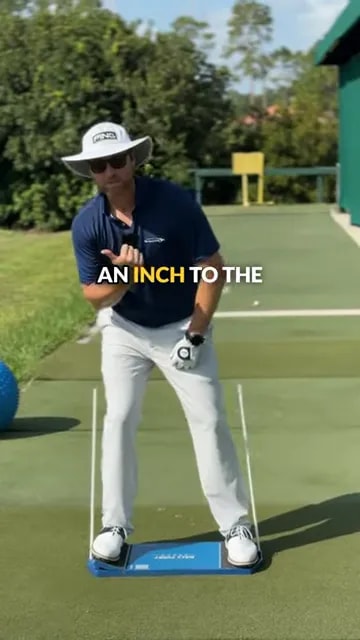 golfer standing on blue training board demonstrating slight upper body shift to the right