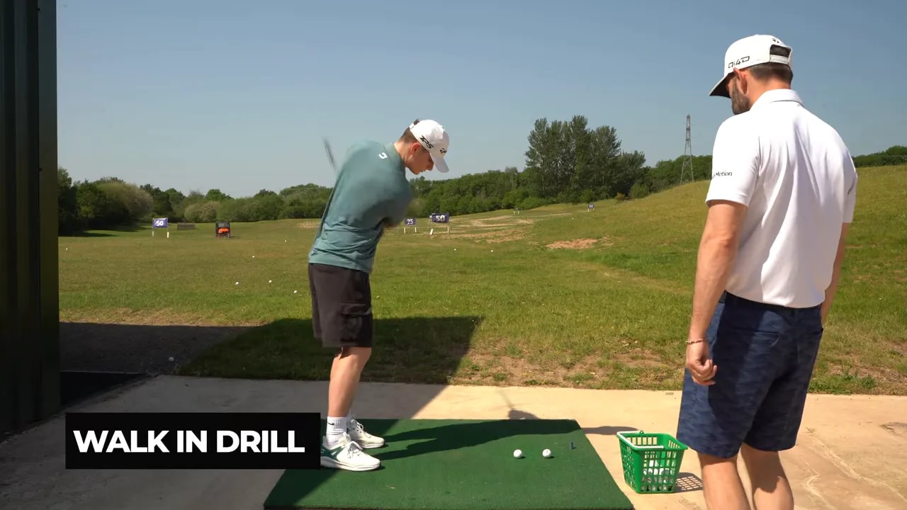 Golfer rehearsing a swing with on screen text reading walk in drill