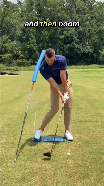 Golfer in impact position after shifting and rotating with forward shaft lean