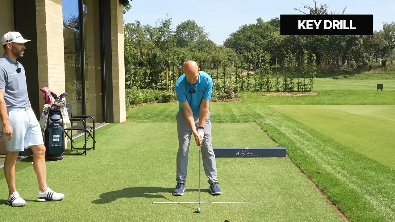 Golfer at address with a ball and a tee extending from the grip