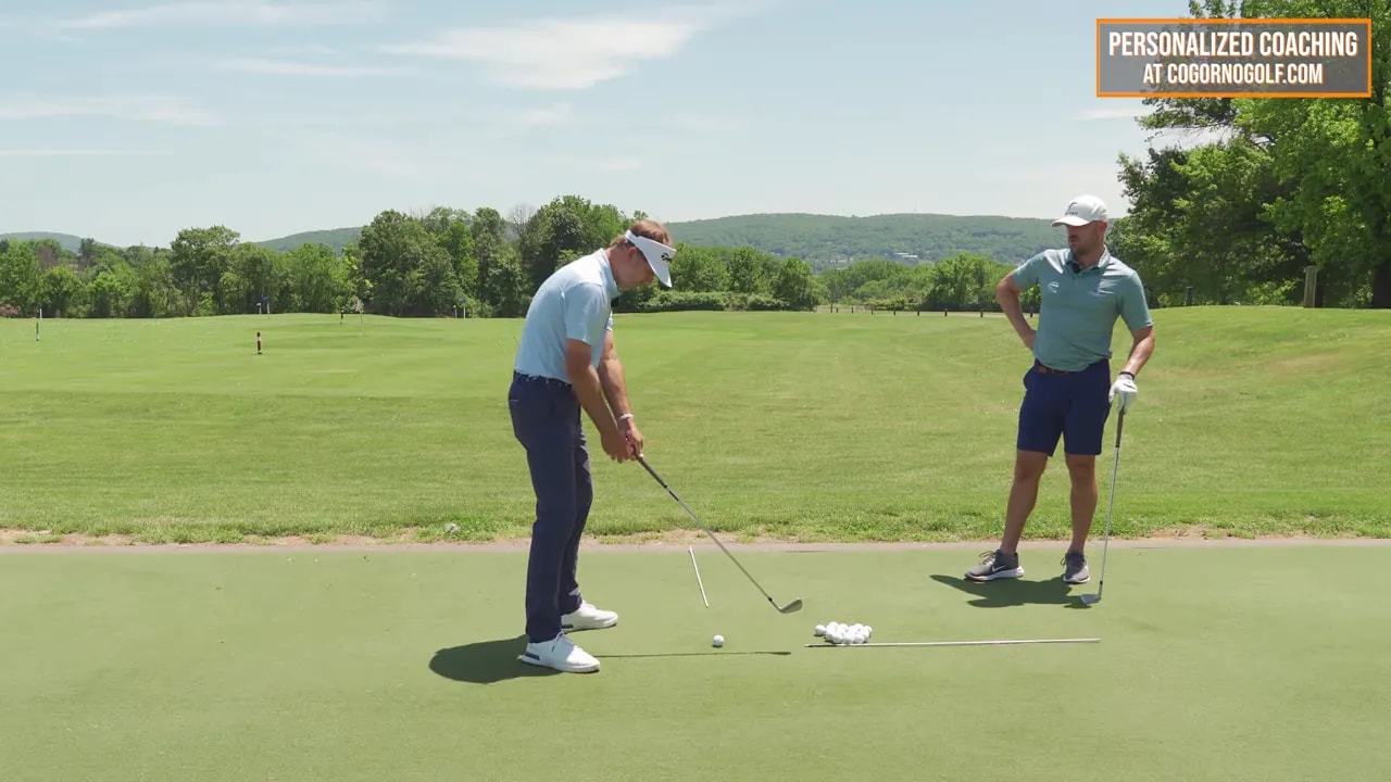Side view of golfer with on-screen hand distance checkpoint text