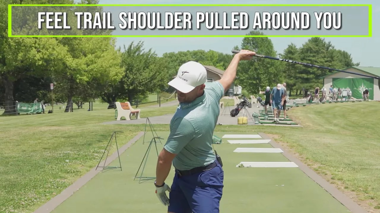 Golfer at top of backswing with circle on trail shoulder and text feel trail shoulder pulled around you