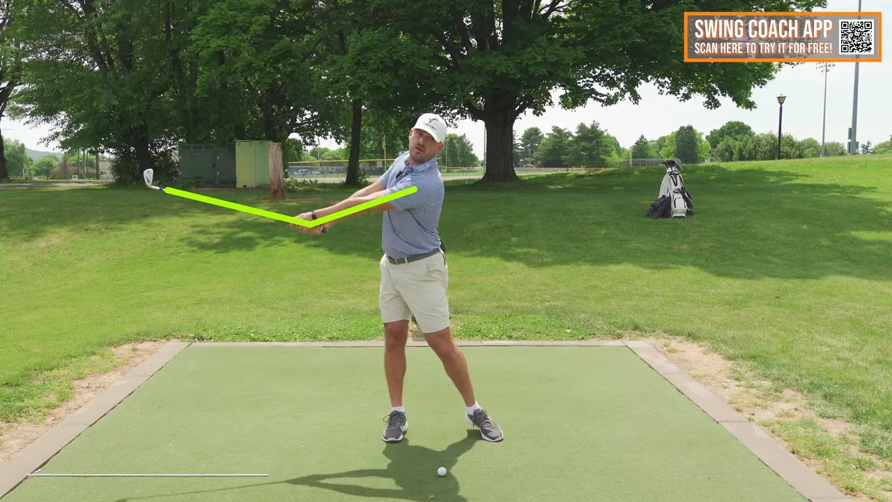 Golfer demonstrating a wide follow-through with arms extended and club moving away from the body